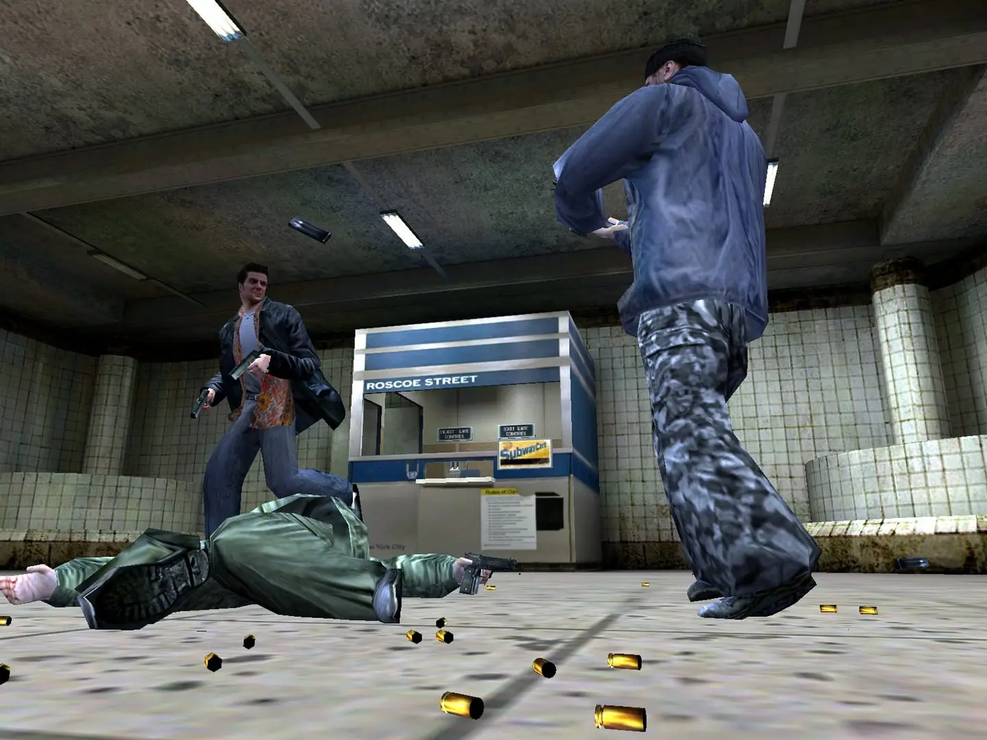 Max Payne — Max runs past a subway ticket booth as a man in a blue jacket reloads, spent casings on the floor