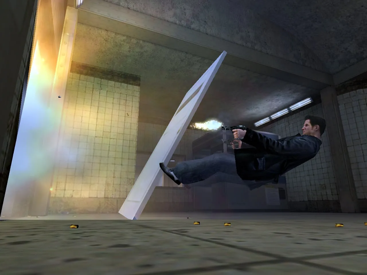 Max Payne — Max dives sideways through a subway station, firing a pistol in mid-air