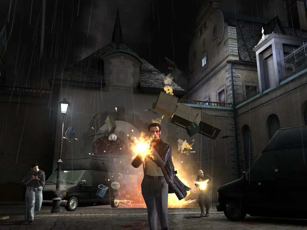 Max Payne 2: The Fall of Max Payne — Max fires a pistol on a rainy night street beside a street lamp, debris flying from an explosion
